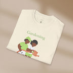 Folded t-shirt with 'Gardening' text and illustration of two people gardening on a beige background