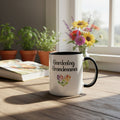 White mug with black handle featuring 'Gardening Grandmama' text and colorful heart design on a beige background