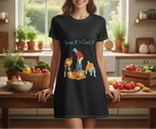 Woman wearing a black t-shirt dress with 'Grow It & Cook It' design in a kitchen.