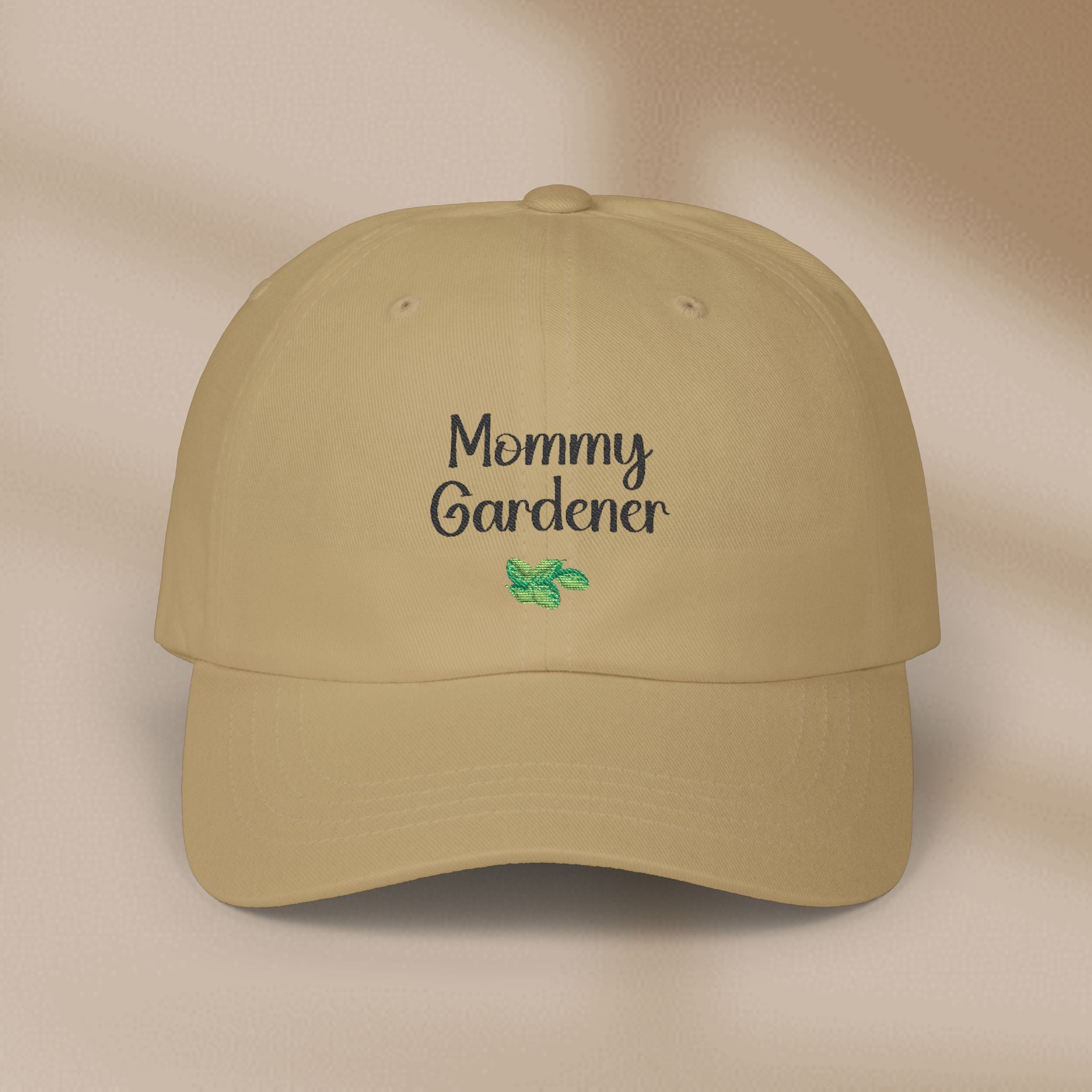 Beige cap with 'Mommy Gardener' text and a green leaf on a beige background