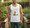 Man wearing a white tank top with a gardening graphic and text in a garden setting