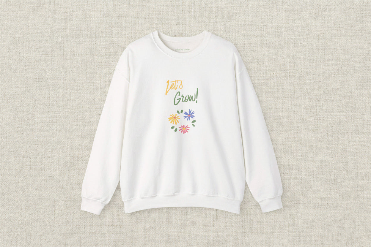 White sweatshirt with 'Let's Grow!' text and floral design on a white background