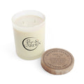 Candle with 'Rise & Garden' logo and wooden lid on a white background