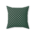 Green pillow with white polka dots on a white background