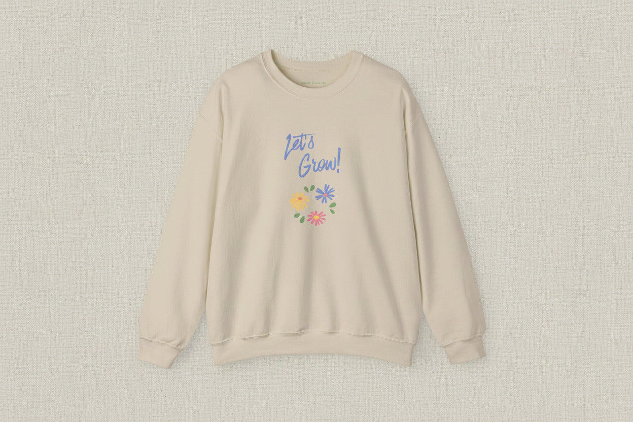 Beige sweatshirt with 'Let's Grow!' text and floral designs on a white background