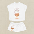 White t-shirt and shorts set with autumn-themed design and text on a white background