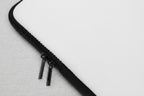 Close-up of a black zipper on a white background