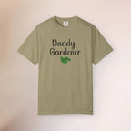 Khaki t-shirt with 'Daddy Gardener' text and a leaf graphic on a beige background