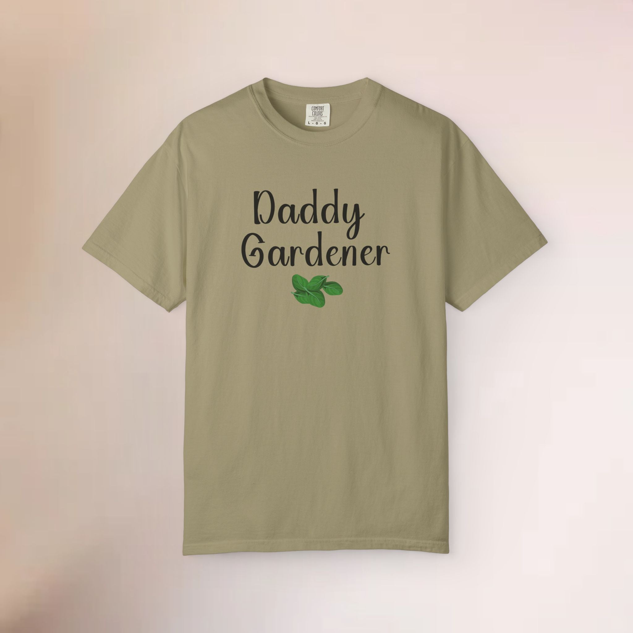 Khaki t-shirt with 'Daddy Gardener' text and a leaf graphic on a beige background