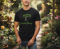 Man wearing a black t-shirt with 'Garden Strong' design in a garden setting