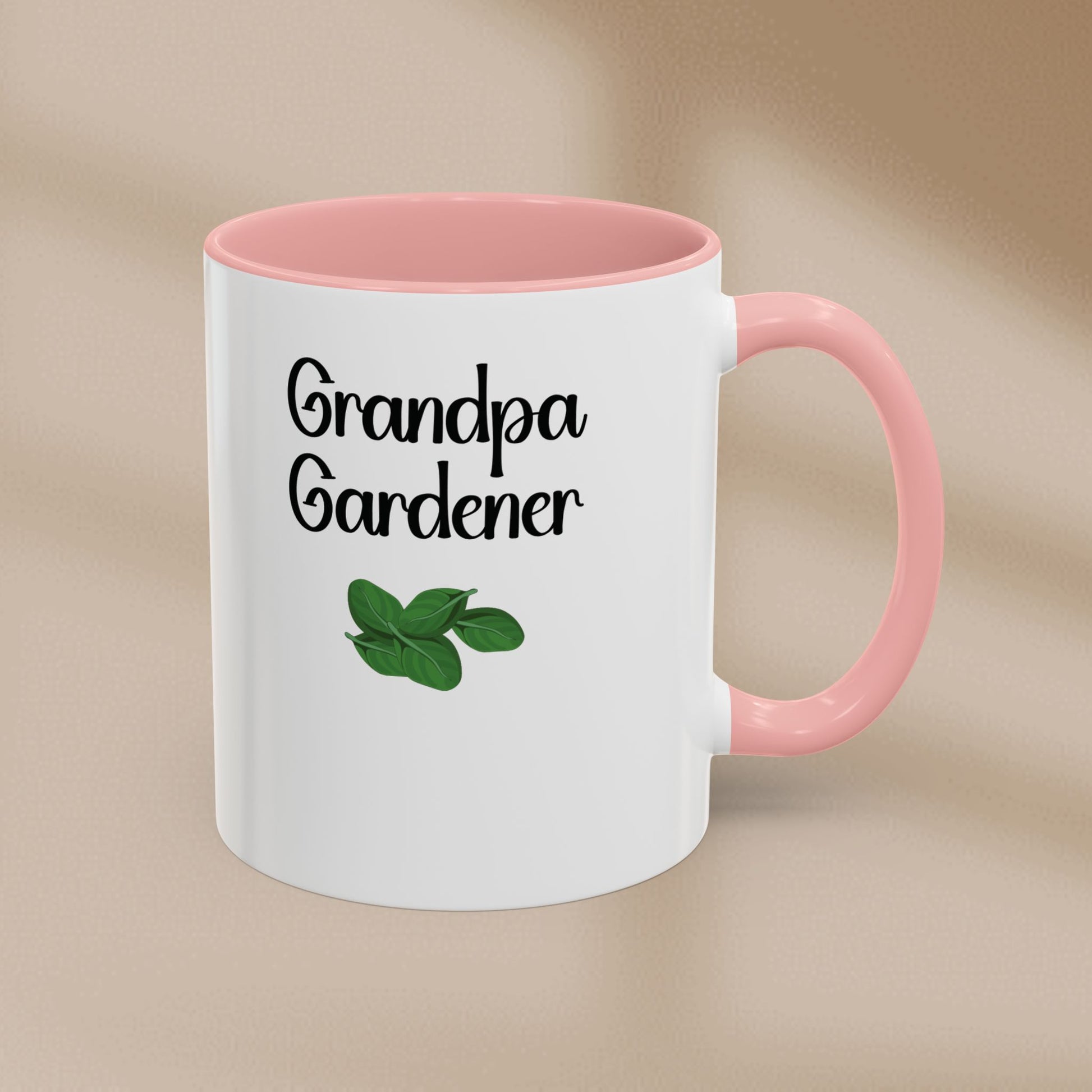 White mug with pink interior and handle featuring 'Grandpa Gardener' text and leaf illustration on a beige background