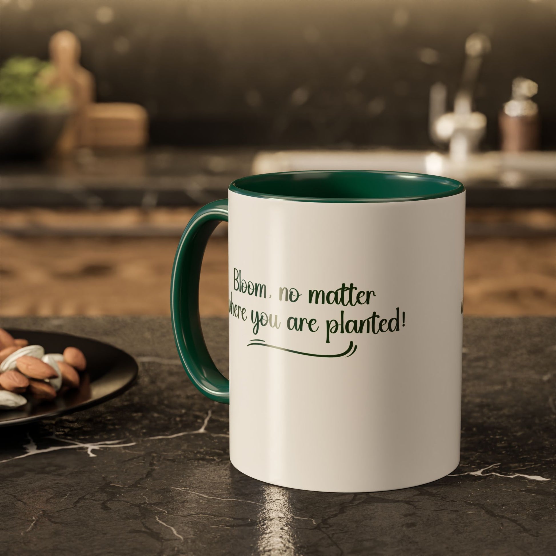 White mug with green interior and handle on a kitchen counter with text 'Bloom, no matter where you are planted!'.