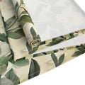 Roll of green leaf-patterned fabric on a white background