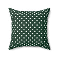 Green pillow with white polka dots on a white background