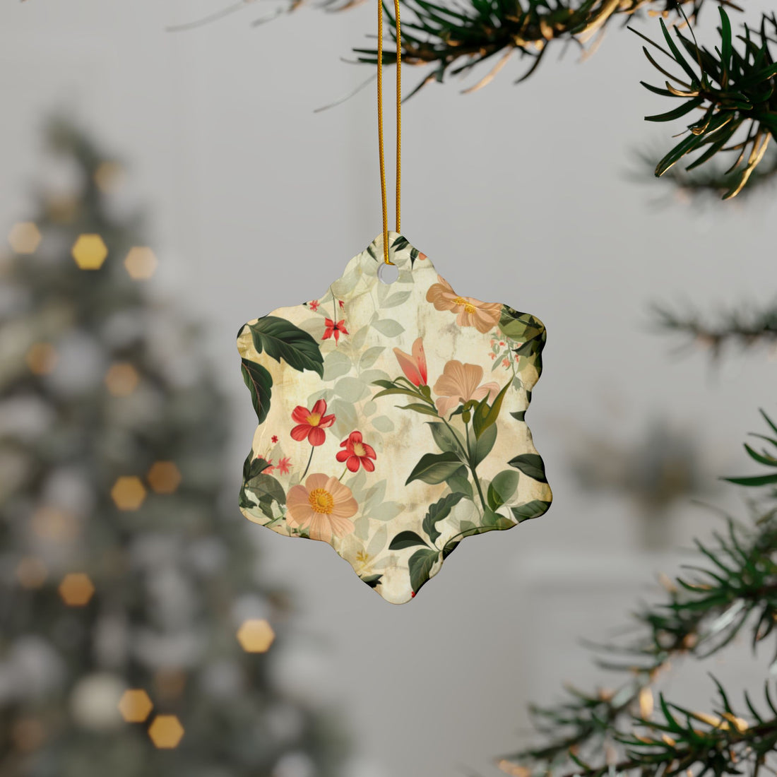 Round floral ornament hanging from a tree branch with a blurred festive background.