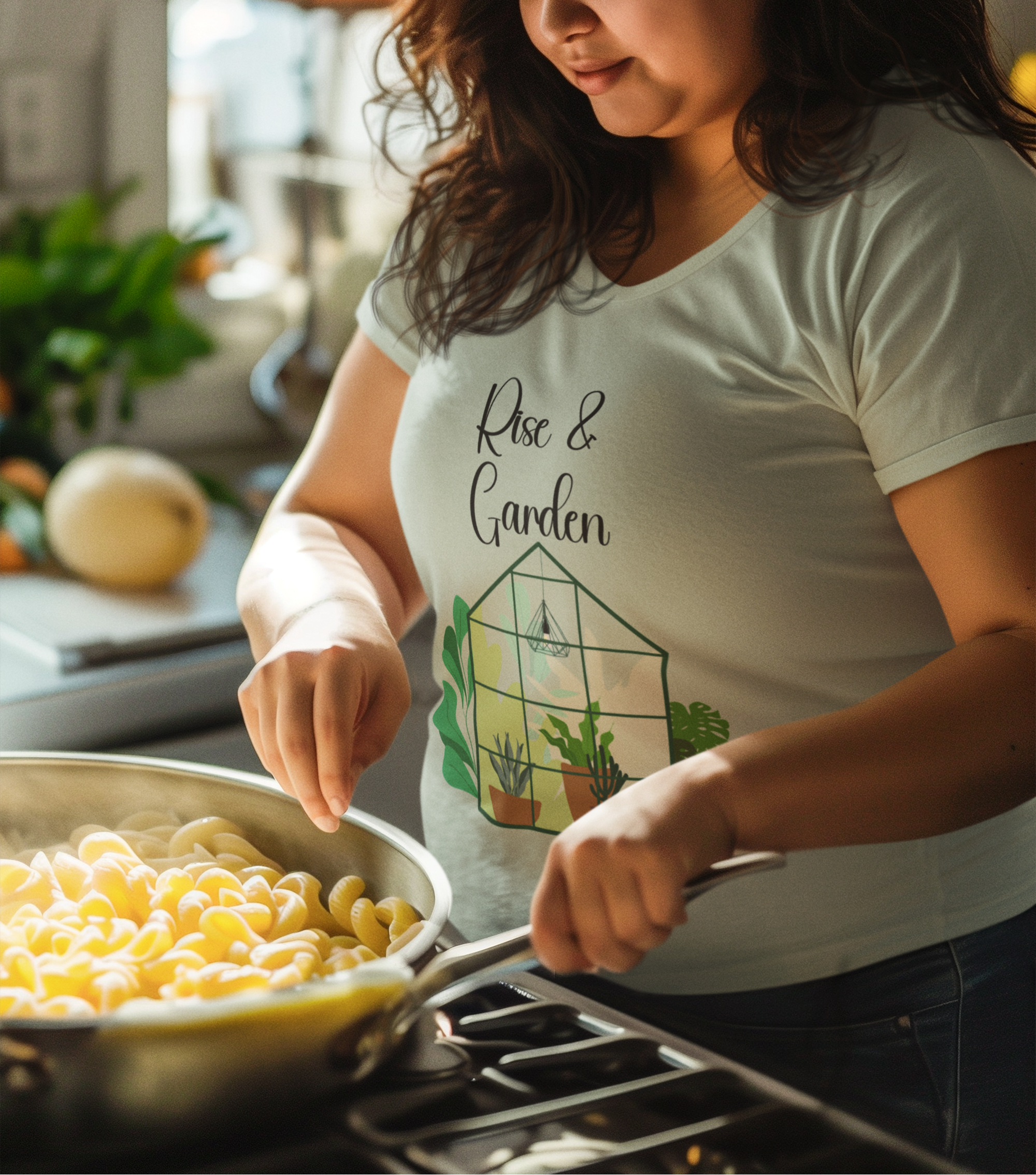 Woman cooking in a kitchen wearing a 'Rose & Garden' t-shirt.