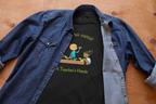 Black t-shirt with graphic design and text 'Inching Hands, A Teacher's Hands' on a blue denim shirt.