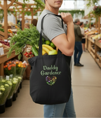 Black tote bag with groceries and 'Daddy Gardener' text on a light green background
