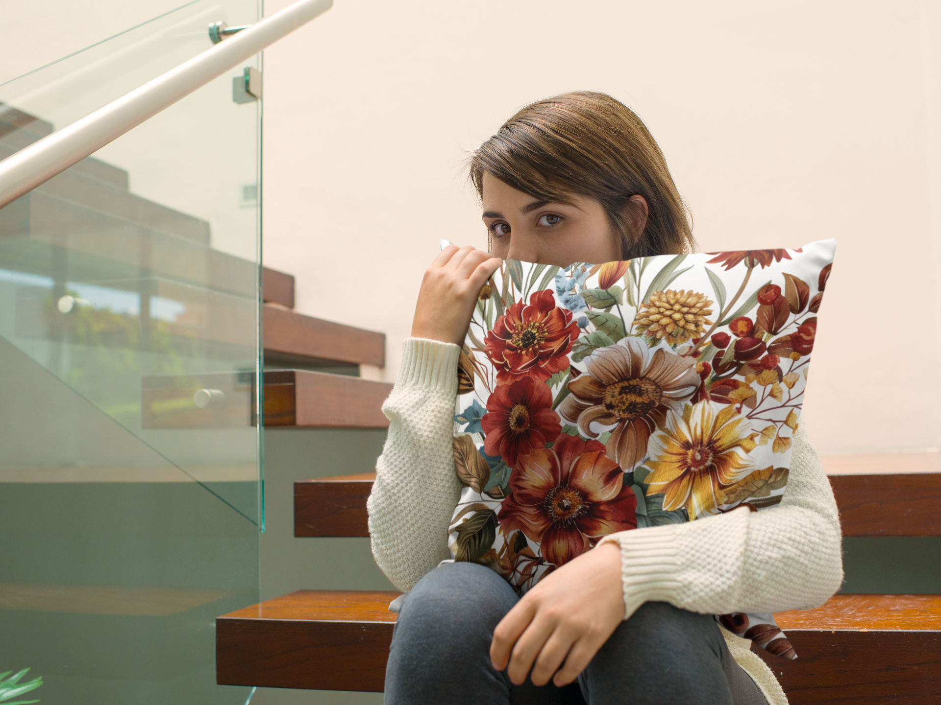 Person holding a floral-patterned pillow in an indoor setting