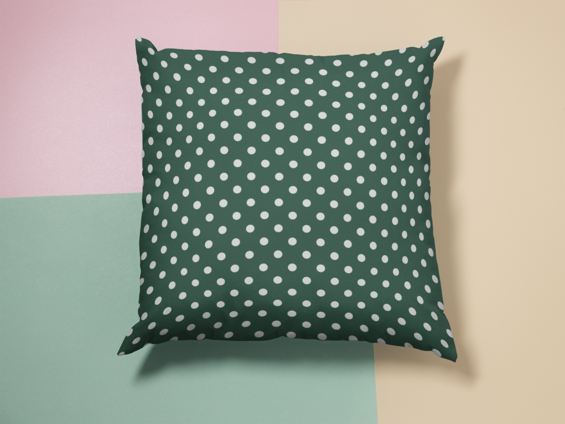 Green pillow with white polka dots on a colorful background