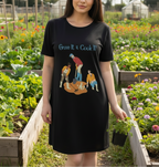 Person wearing a black t-shirt dress with gardening graphic in a garden setting