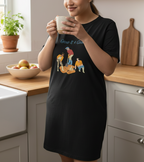 Person wearing a black t-shirt with a graphic design in a kitchen