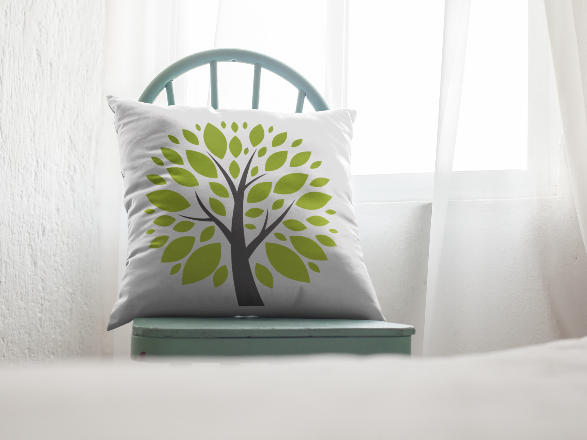 Decorative pillow with a tree design on a white couch