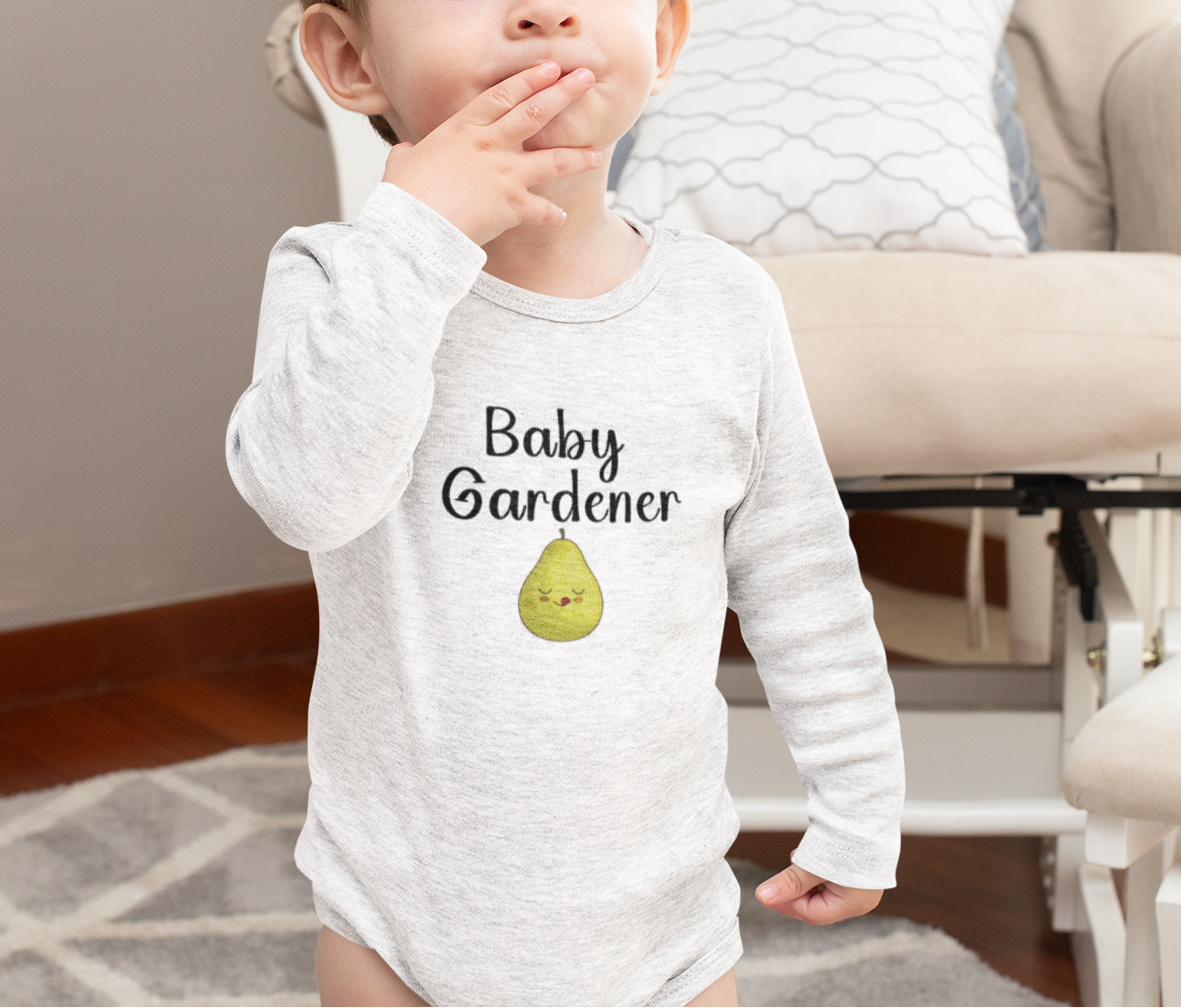 Child wearing a 'Baby Gardener' onesie in a home setting