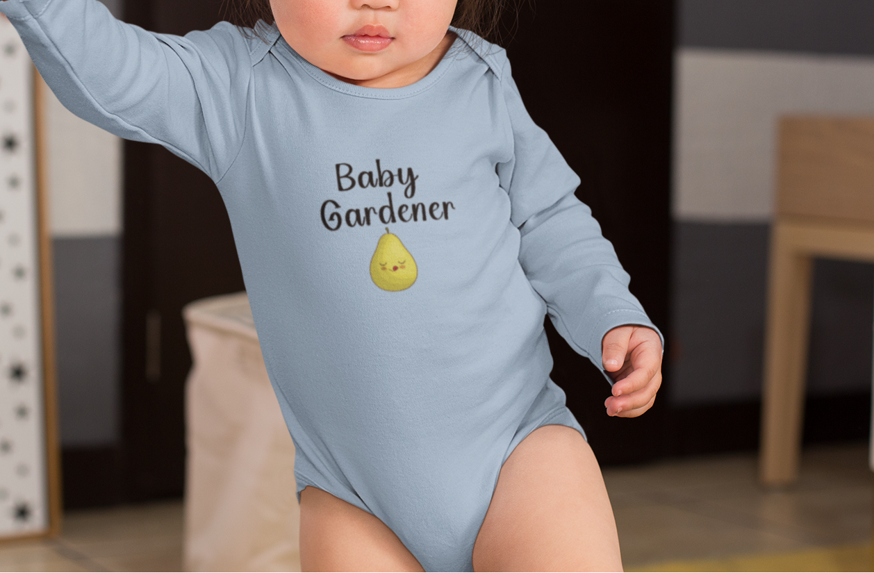 Child wearing a blue 'Baby Gardener' onesie standing with an adult's hand.