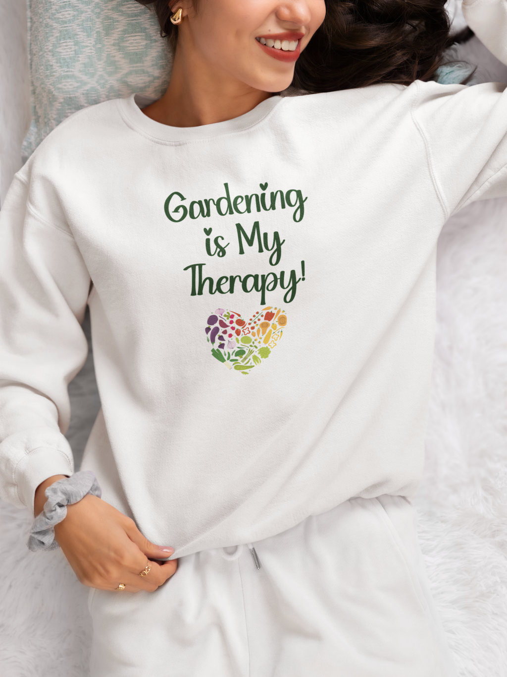 Person wearing a white sweatshirt with 'Gardening is My Therapy!' text and colorful heart design.
