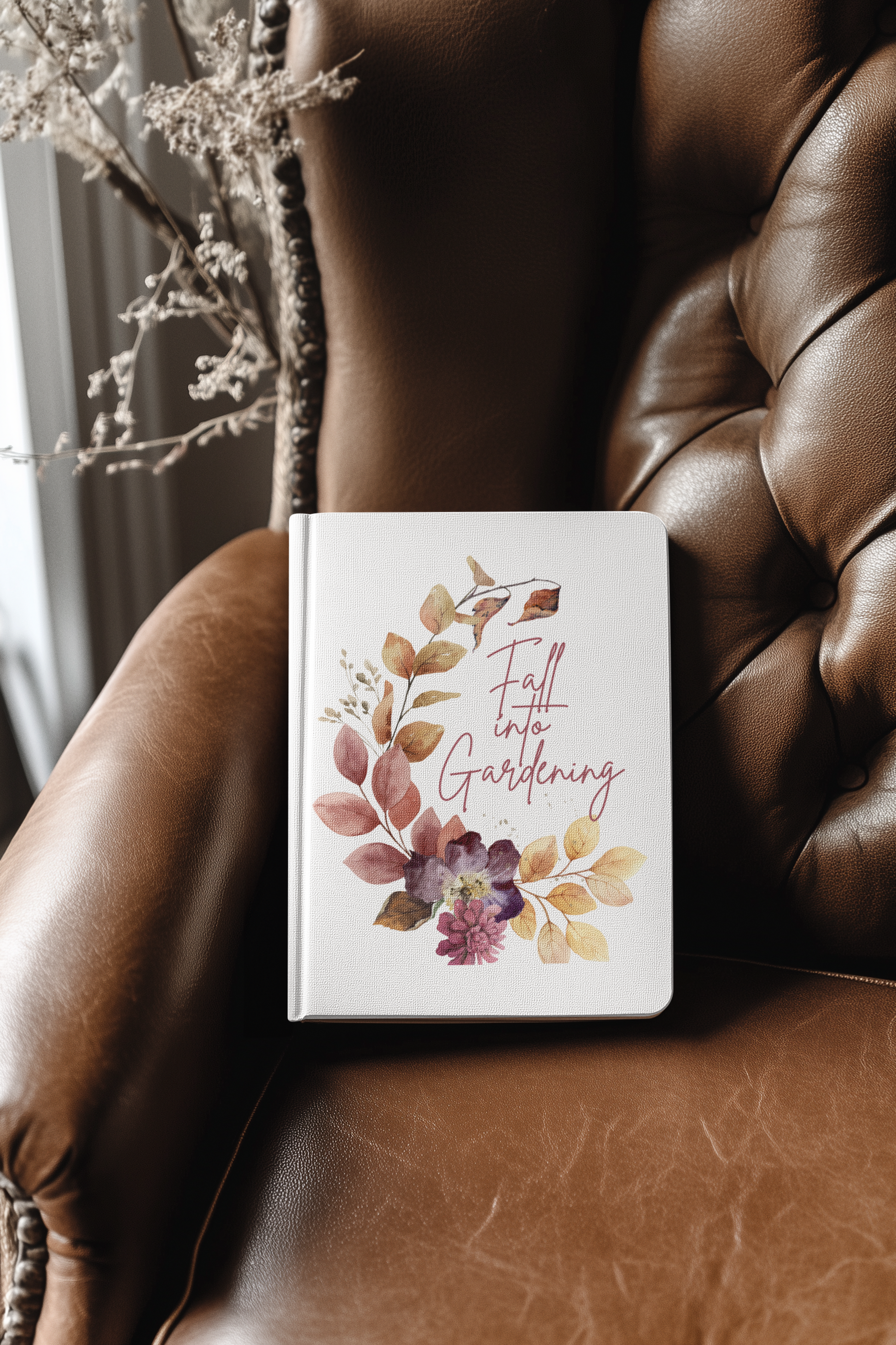 Notebook with floral design and text on a brown leather surface