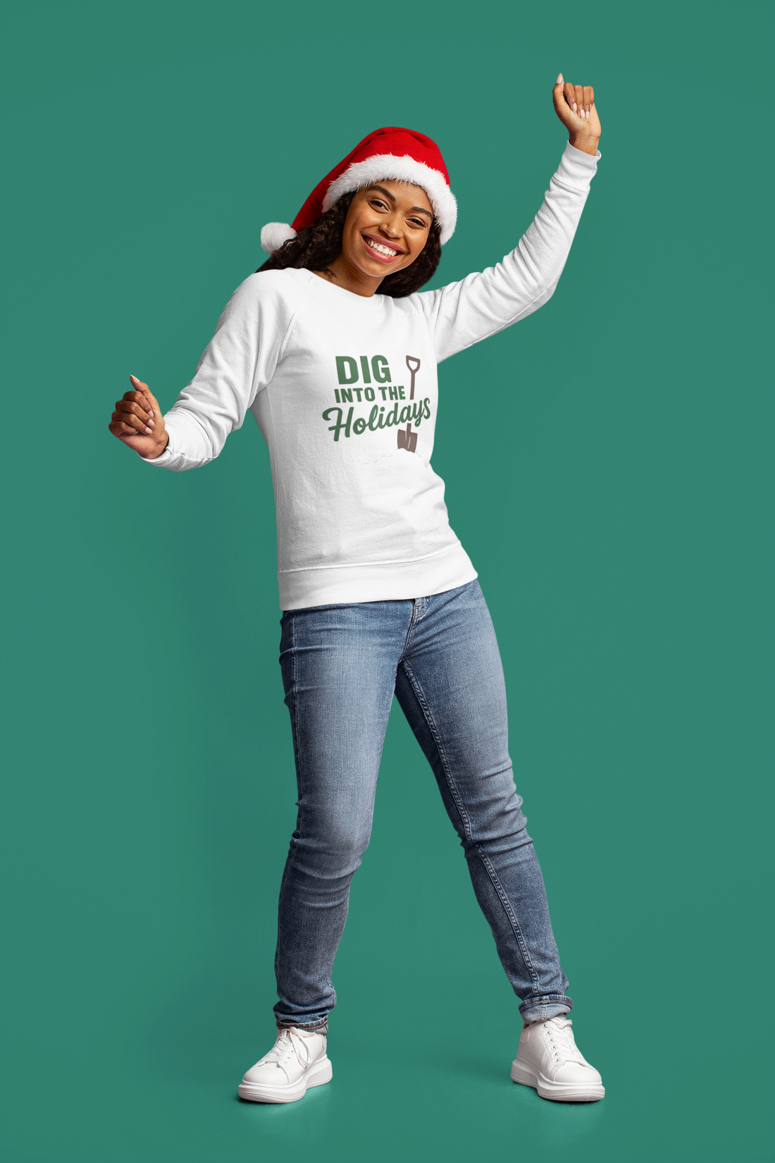 Person wearing a white sweatshirt with holiday text and a Santa hat on a green background