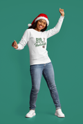 Person wearing a white sweatshirt with text and a Santa hat on a green background