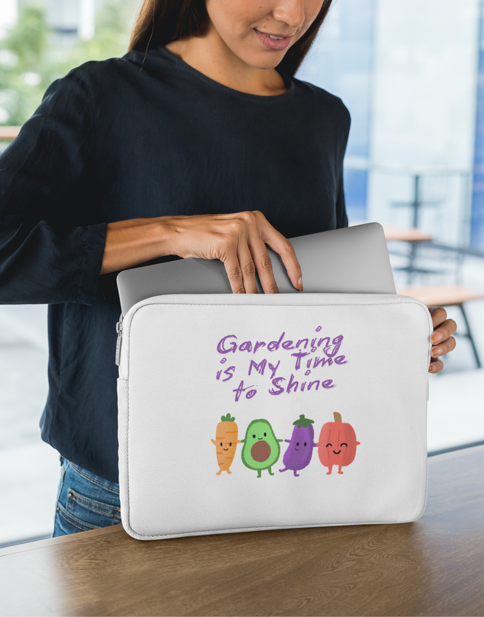 Woman holding a laptop case with gardening-themed design