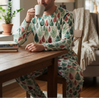Person wearing a patterned pajama set sitting at a wooden table, holding a mug.