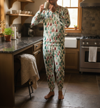 Person wearing a festive pajama set in a kitchen