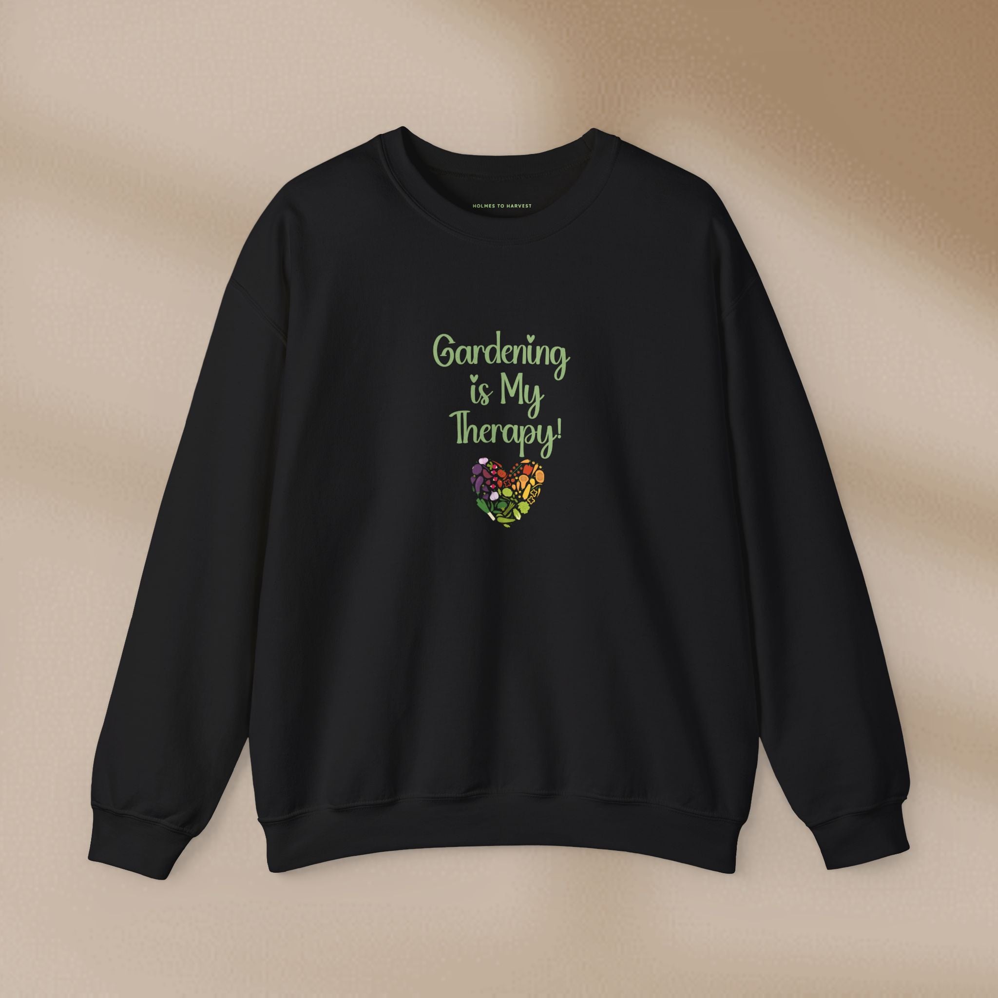 Black sweatshirt with 'Gardening is My Therapy!' text and heart design on a beige background