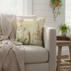 Decorative pillow with floral and butterfly design on a beige background