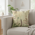 Decorative pillow with floral pattern on a beige armchair in a bright room.
