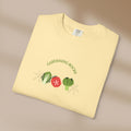 Yellow t-shirt with 'Gardening Rocks' text and vegetable graphics on a beige background