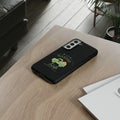 Black phone case with green design on a wooden surface