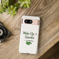 Phone case with 'Wake Up & Garden' text on a wooden surface