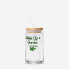 Clear glass tumbler with straw and wooden lid, featuring 'Wake Up & Garden' text and leaf design on a white background.