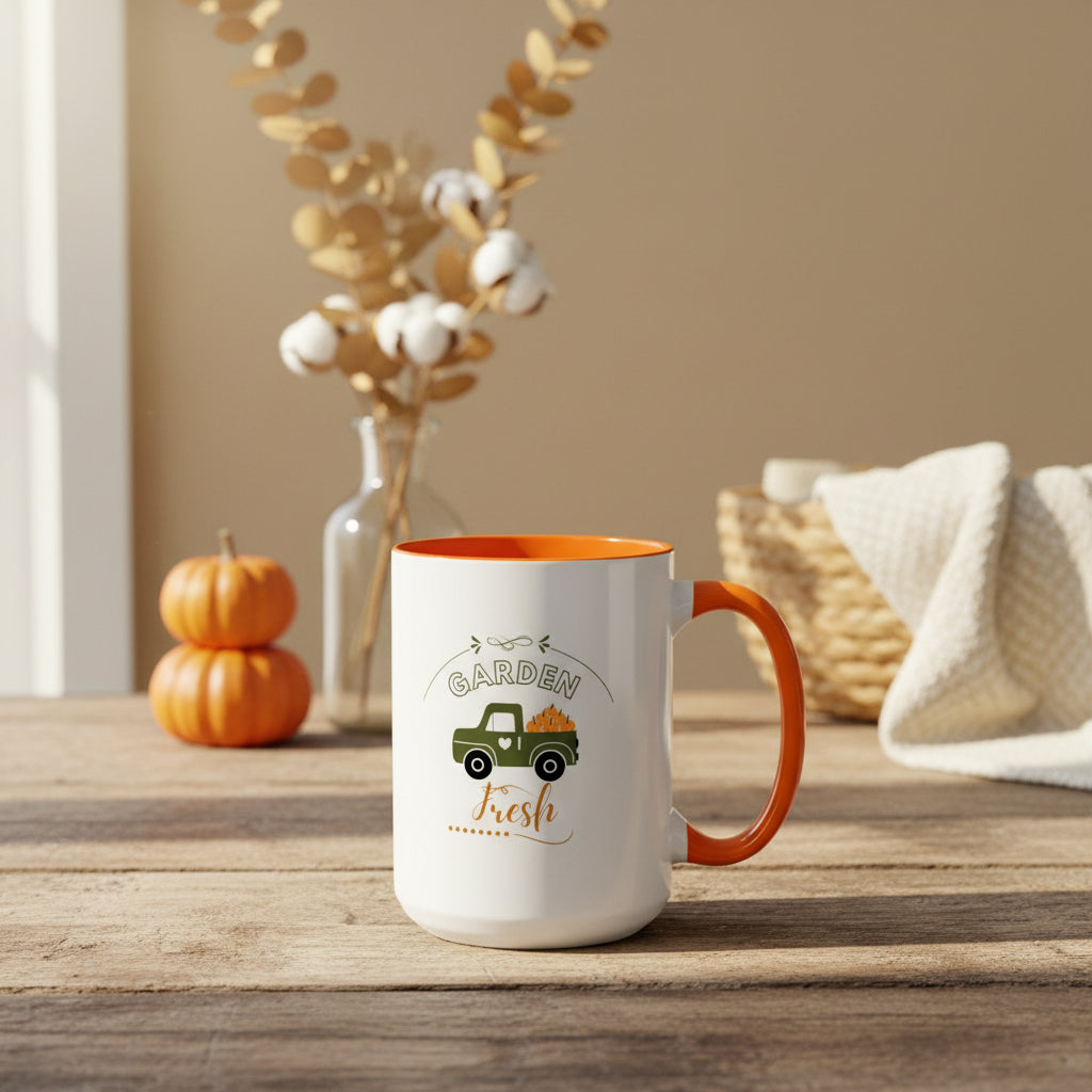 White mug with orange interior and handle featuring a truck and pumpkin design on a beige background.
