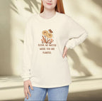 Person wearing a cream-colored sweatshirt with a floral design and text, standing against a neutral background.