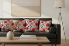 Decorative pillows with floral patterns on a black sofa in a living room setting.