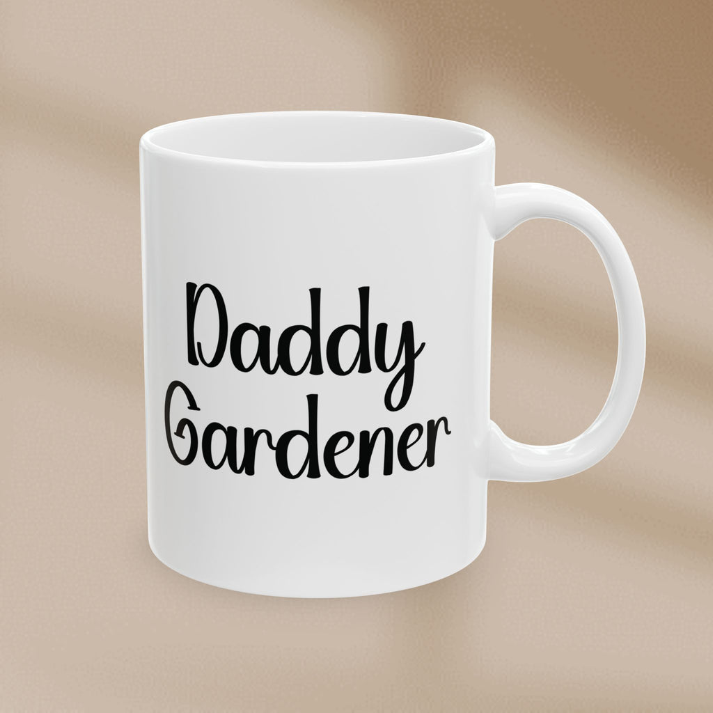 White mug with 'Daddy Gardener' text on a beige background