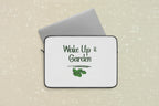Laptop sleeve with 'Wake Up & Garden' text and leaf graphic on a white background