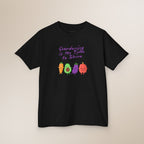 Black t-shirt with colorful avocado characters and text on a beige background