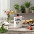 Mug with 'Gardening Grandma' text on a table with plants and flowers in the background
